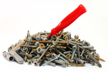 Pile of screws with a screwdriver in it