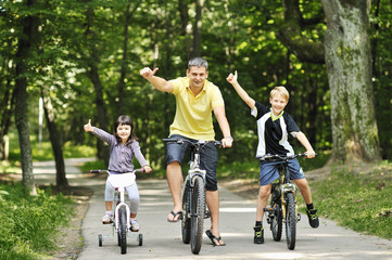 Family in the park on a bicycles