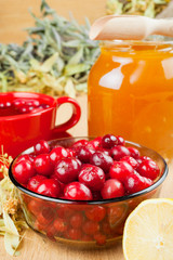 cranberries, jar with honey, fruit tea cup, healing herbs and le