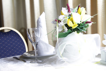 tableware and flower bouquet in restaurant