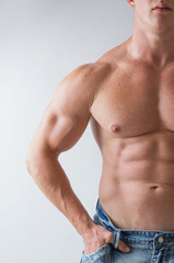 Fototapeta na wymiar Muscular male torso of bodybuilder, studio shot