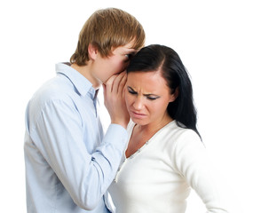 Man telling terrible secret to a woman. Isolated on white.