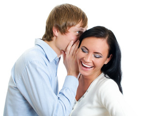 Man whispering to a woman. Isolated on white.