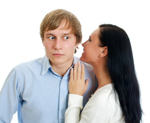Woman whispering to a man. Isolated on white.