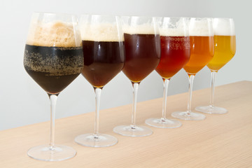 six glasses with different beers