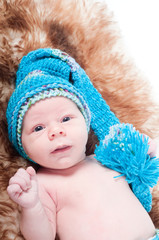 Newborn baby on blue knitted cap