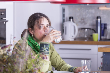 woman having a break from housework at home