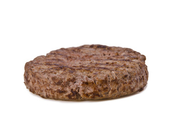 Close-up of a grilled beef patty with distinct grill marks, captured on a white background. Perfect as a classic burger ingredient or for food advertising and restaurant menu design