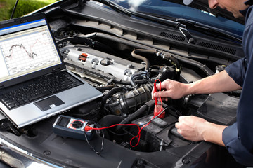 Fototapeta Car mechanic working in auto repair service. obraz