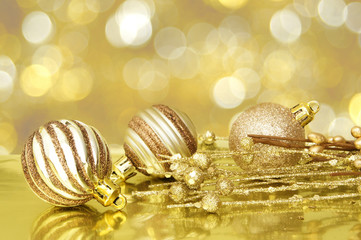 Gold Christmas scene with baubles and abstract light background