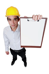 Engineer holding up a blank clipboard