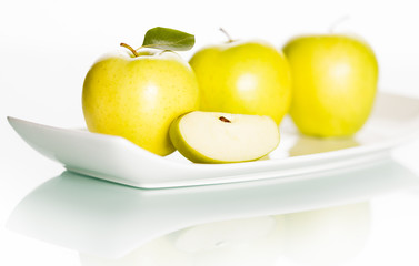 Apples on plate isolated on white background.