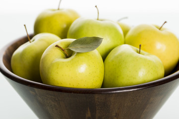 Close up of apples in wooden basket.