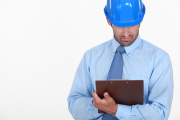 Businessman in a hardhat with a clipboard