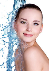 Smiling woman under stream of water