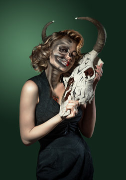 Portrait of a woman with cow's skull in her hands