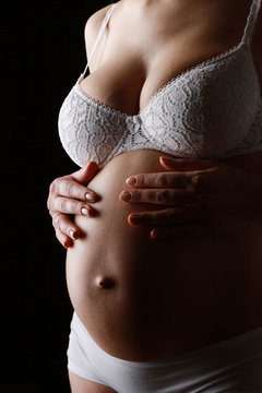 Pregnant woman isolated on black background