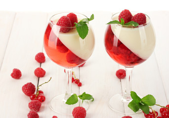 fruit jelly with berries in glasses on wooden table