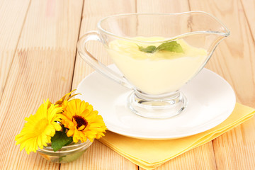 Mayonnaise in bowl on wooden table