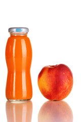 Delicious peach juice in glass bottle and peach next to it