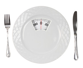 Diet meal. White plate with weight scale