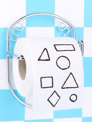 Roll of toilet paper on  holder fixed to wall