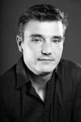 Handsome man with short brown hair. Black and white studio.