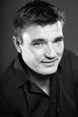 Fototapeta premium Handsome man with short brown hair. Black and white studio.