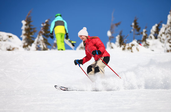 Young female skier on a snowy slope