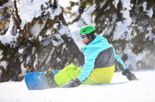 Snowboarder resting on a slope