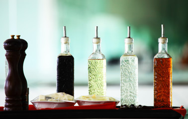Oil bottles & peppers grinders in restaurant