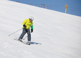 Young man learning to ski on a snowy slope