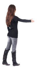 back view of businesswoman  reaches out to shake hands.