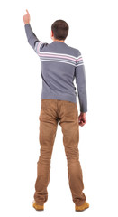 Fototapeta premium Back view of pointing young men in sweater and jeans