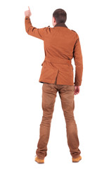 Fototapeta premium Back view of man in jacket pointing.