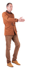 Naklejka premium handshake in walking man's in brown jacket and jeans.