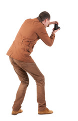 Back view of man photographing