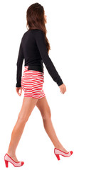 back view of going  woman  in red dress.