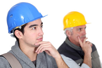 Two pensive construction workers.