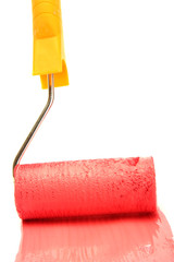 Obraz premium Paint roller with red paint isolated on white