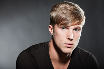 Fototapeta premium Fashion beauty portrait of young man with short brown hair.