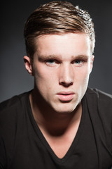 Obraz premium Fashion beauty portrait of young man with short brown hair.