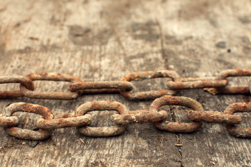 Rusty chain and weathered wood background