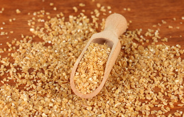 arnautka in wooden spoon on wooden background close-up