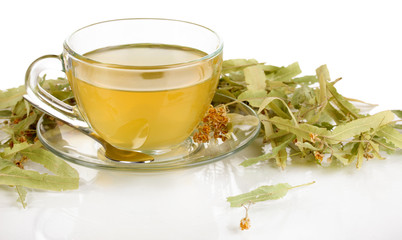Glass cup of tea with linden isolated on white