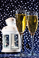 Two glasses of champagne and a white lantern