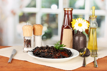 Black spaghetti on bright background