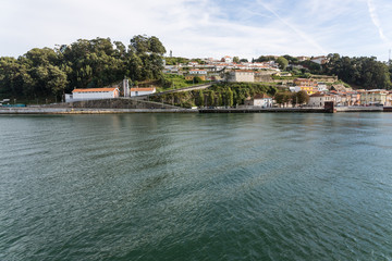 Fototapeta na wymiar View of Porto city at the riverbank (Ribeira quarter) and wine b