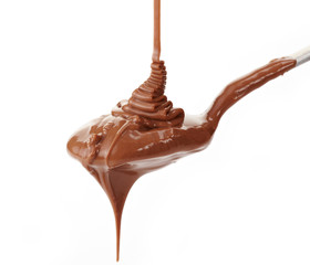 Melted chocolate flowing on a spoon