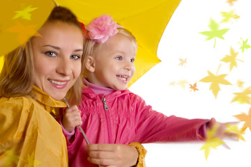 Mother and daughter under umbrella